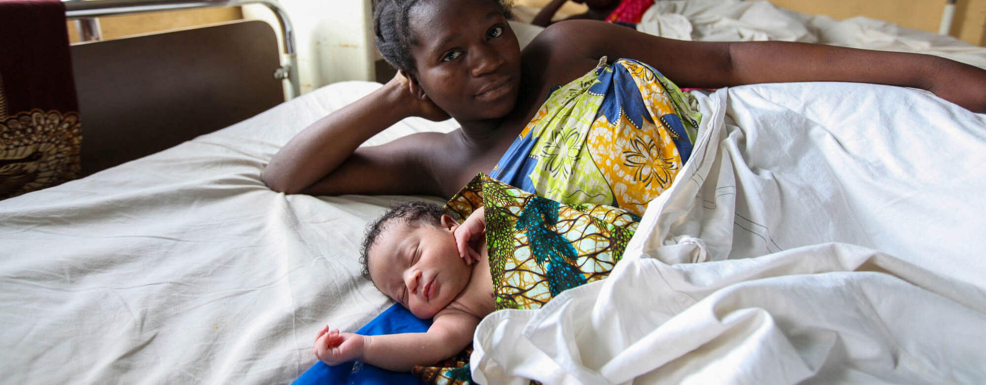 Mother with newborn in hospital bed Mother with newborn in hospital bed