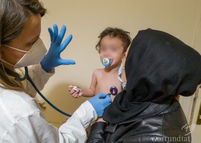 Paediatrician listens to a small patient - Refugees in Greece