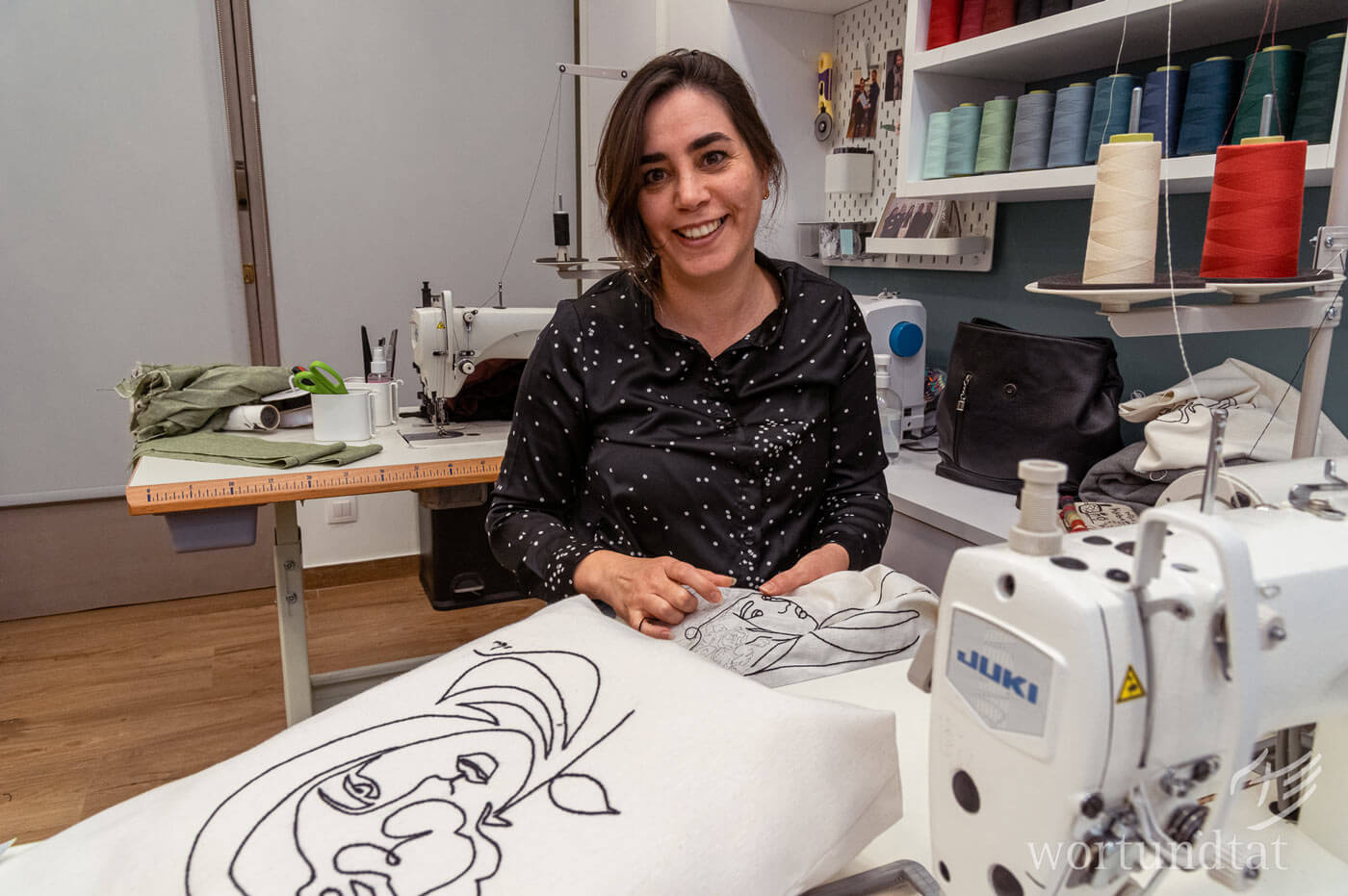 Woman embroidering a figure on a piece of fabric