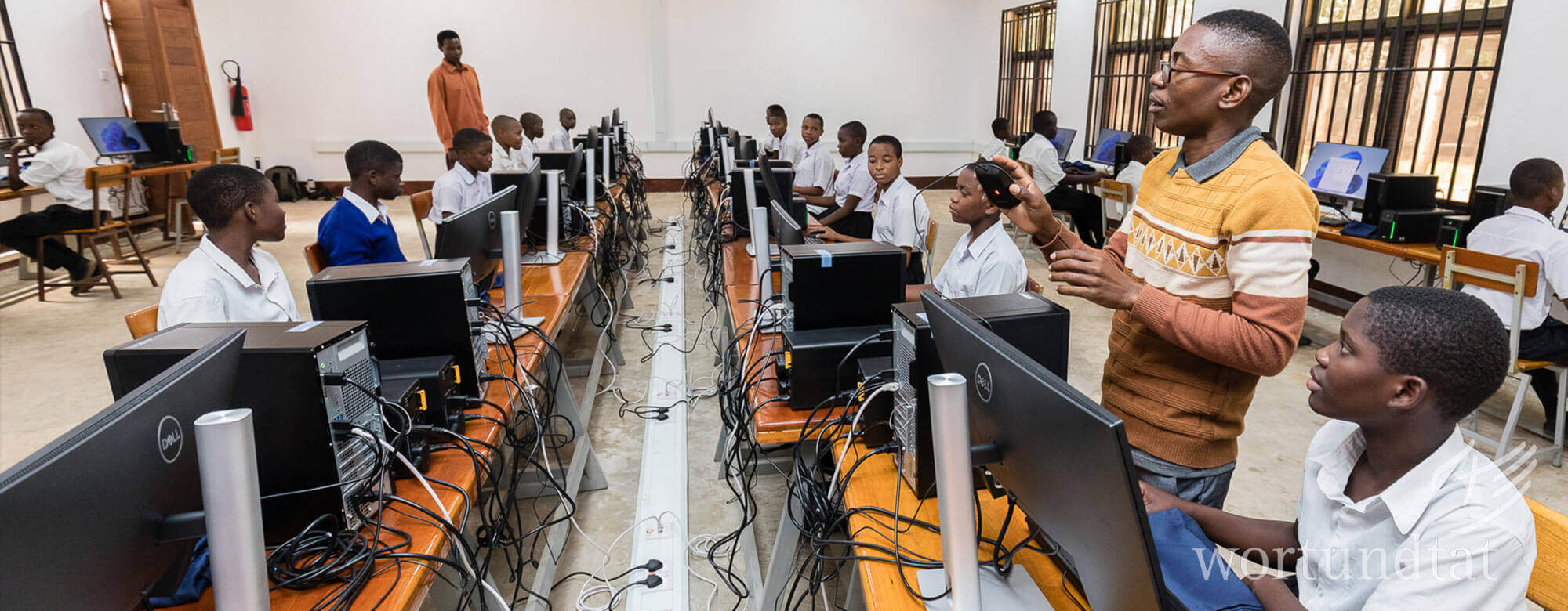 Computer Lessons IT teachers and many students at computer workstations