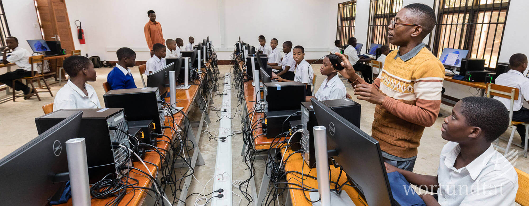 IT teachers and many students at computer workstations